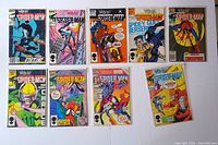 Image showing 10 comic books laid flat including issues #10 to 17 and #19, colorful Spider-Man covers in bags with backboards.