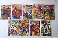 Top view showing all 10 Web of Spider-Man comic books arranged horizontally with vibrant front covers visible. Issues included are #70-76, #78, #79 plus extra #73.