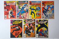 Top-down view of seven Web of Spider-Man comic books, issues #30 and #34 through #39, showing colorful and varied cover illustrations.