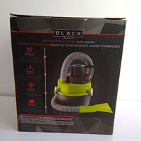 Box showing Black Series multifunction wet and dry auto vacuum cleaner with hose and nozzle indicated on the front