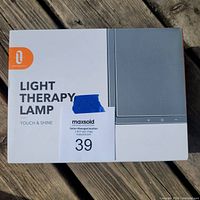 Box of the light therapy lamp showing the brand TaoTronics and model Touch & Shine.
