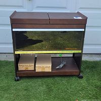 Full front view of the vintage buffet server showing wood finish, mirrored front labeled 'Cosmopolitan', bottom oven, and casters.