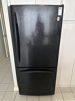 Front closed view of black GE Profile refrigerator/freezer