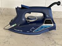 Side view of Rowenta Steamforce steam iron showing power (1800W) and steam functions.