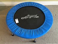 Top view of the round blue-padded fitness trampoline with 'exergear by York' logo on the jumping mat.