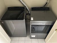 Wide front view of washer and dryer installed side by side