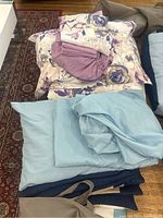 Floral patterned queen size bedding with purple and beige tones including pillow covers.