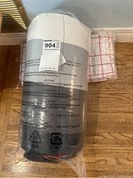 Photo of 7 piece bedding set items sealed in clear plastic packaging, showing white pillow with gray on bottom and labeled 'maxsol 904'.