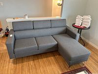 Front view of entire sectional sofa showing three seats and chaise