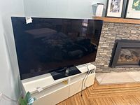 Sony 55-inch flat screen TV on white console, front view