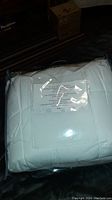 Queen size duvet packed and sealed in clear plastic packaging with label showing product description.