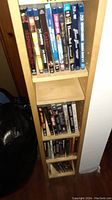 Shelf with assorted DVD and Blu-ray movies including The Expendables, X-Men, Logan, Carrie, and more.
