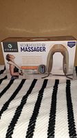 Front view of the Eternal Neck & Shoulder Massager product box showing the product image and branding.