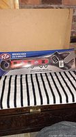 Photo showing the front view of the STP wrench rack in original packaging, featuring a large wrench design with red handle and STP logo.