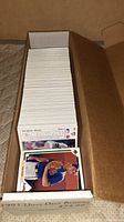 Box filled with 1991 Upper Deck baseball cards, showing tops and edges of cards, arranged vertically in cardboard box.