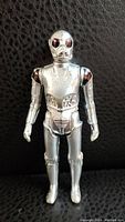 Front view of 1978 Star Wars Death Star Droid action figure showing silver metallic finish, red eyes, and mechanical detailing.
