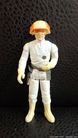 Front view of the 1981 Star Wars Cloud Car Pilot action figure showing white suit, orange and white helmet, gloved hands, and boots.