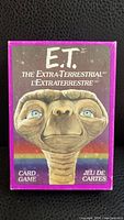 Front of 1982 E.T. The Extra-Terrestrial card game box showing illustration of E.T. face with purple border.