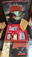 Complete Fury of Dracula game box opened to show organized components inside including board, cards, and tokens.