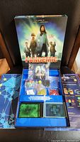 Full view of Pandemic board game box open, showing organized contents inside including game board and tokens.