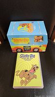 Collector's box designed as the Mystery Machine with Scooby-Doo: Where Are You! text and DVD case with Scooby-Doo cartoon illustration on cover shown on black background.