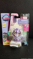 Front view of sealed Littlest Pet Shop Upesi Duma figure in original packaging, showing the figure and included accessory clearly.