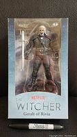 Front of sealed Witcher Geralt figure box, showing figure inside with sword and clear plastic window.