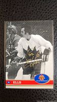 Front of the Ron Ellis signed hockey card showing player in Maple Leafs uniform and gold ink autograph.