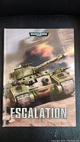 Front cover of the Warhammer 40,000 Escalation Hardcover Sourcebook depicting a detailed tank in combat.