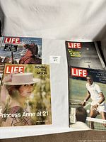 Four Life magazines from the 1960s with distinct covers laid out together