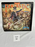 Front of Elton John Captain Fantastic and the Brown Dirt Cowboy LP vinyl album cover showing Elton John playing piano surrounded by fantasy figures