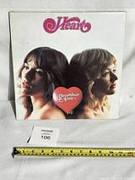 Front cover of the Heart Dreamboat Annie vinyl album with band members' portraits and Heart logo.