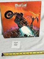 Front cover of Meat Loaf's Bat Out Of Hell vinyl album showing artwork with motorcycle and bat demon