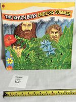 Front cover of The Beach Boys Endless Summer vinyl LP showing colorful illustrated band portraits in a tropical/jungle setting.