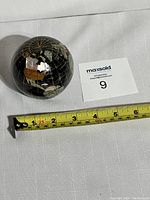 Image of vintage globe paperweight with measuring tape showing approximately 3 inch diameter.