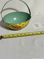 Photo of full Easter basket with measuring tape showing approximately 9.5 inches diameter and metal handle