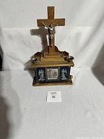 Full view of the wooden box with crucifix and candle holders