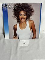 Front cover of the vinyl record album featuring a photo of Whitney Houston smiling against a gradient blue background.