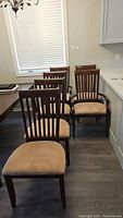 Six chairs arranged in dining area showing overall set composition