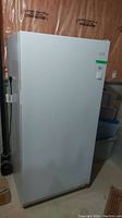 White upright freezer exterior front view