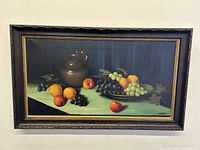 Full view of the antique still-life oil painting on canvas inside wood frame with gold trim.