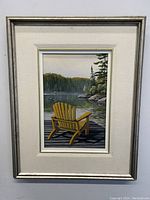 Framed oil painting showing a yellow Muskoka chair on a dock with lake and trees in the background