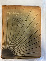 Soft leather cover with gold-stamped title 'Rubaiyat of Omar Khayyam' and sunburst Art Nouveau design