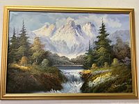 Frontal view of vibrant mountain landscape oil painting signed J Brown in gold painted wooden frame.