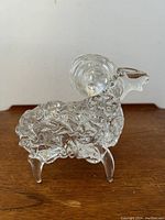 Front side view of clear Murano spaghetti style glass ram sculpture highlighting texture on body and curled ram horns.