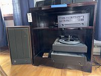 Onkyo receiver on shelf with BSR turntable below and GE floor speaker to the left.