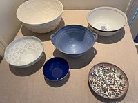 Top view of all six bowls arranged on a table, showing variety of colors, shapes, and sizes