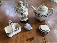 All five Dedham Pottery items grouped on table showing overall set condition and design.