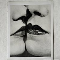 Close-up photo of The Kiss print showing two faces about to kiss, with detailed focus on lips and nose.