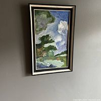 Full view of the framed abstract landscape oil painting hanging on a gray wall.